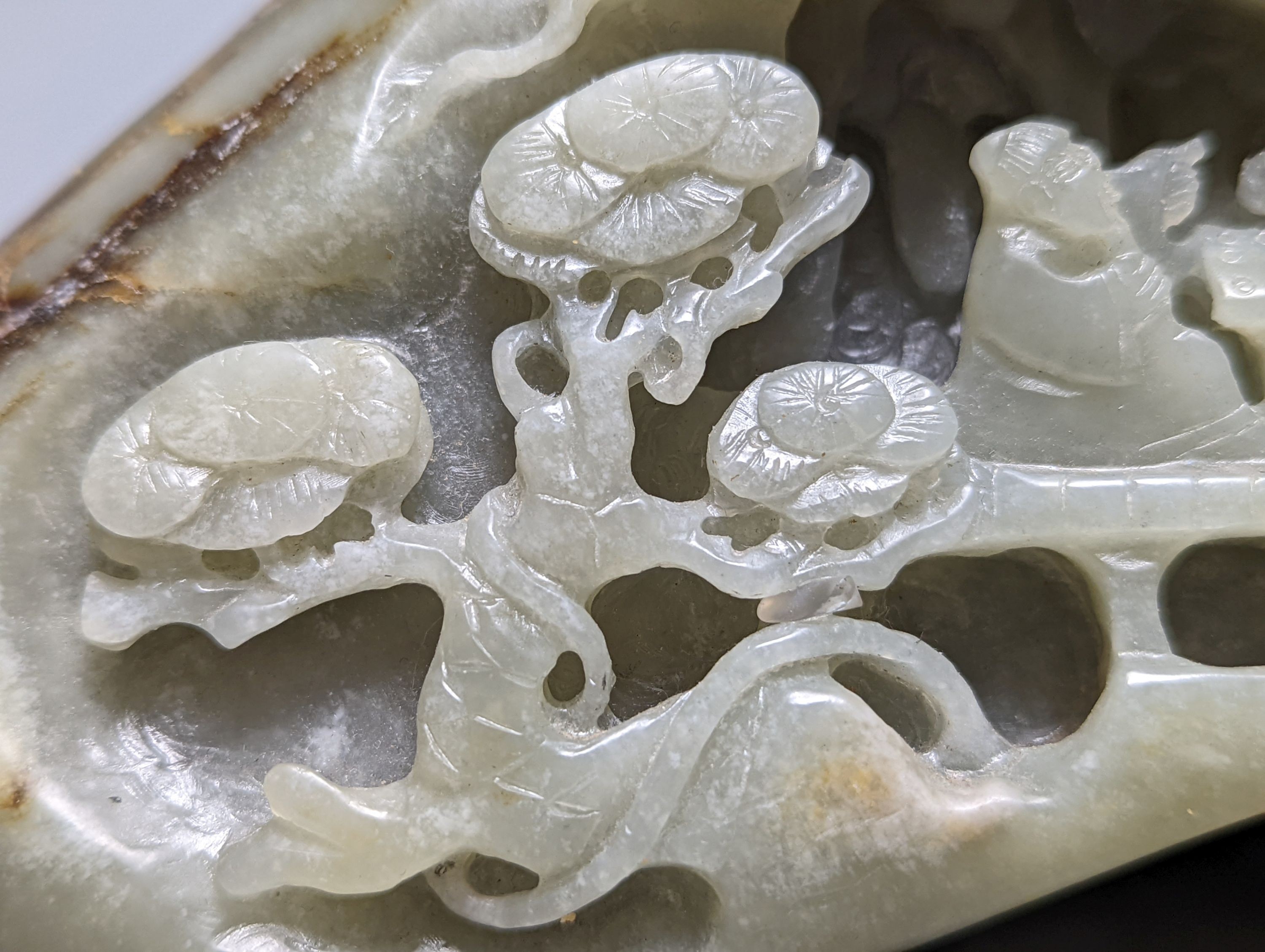A Chinese celadon and russet jade boulder carving 16cm